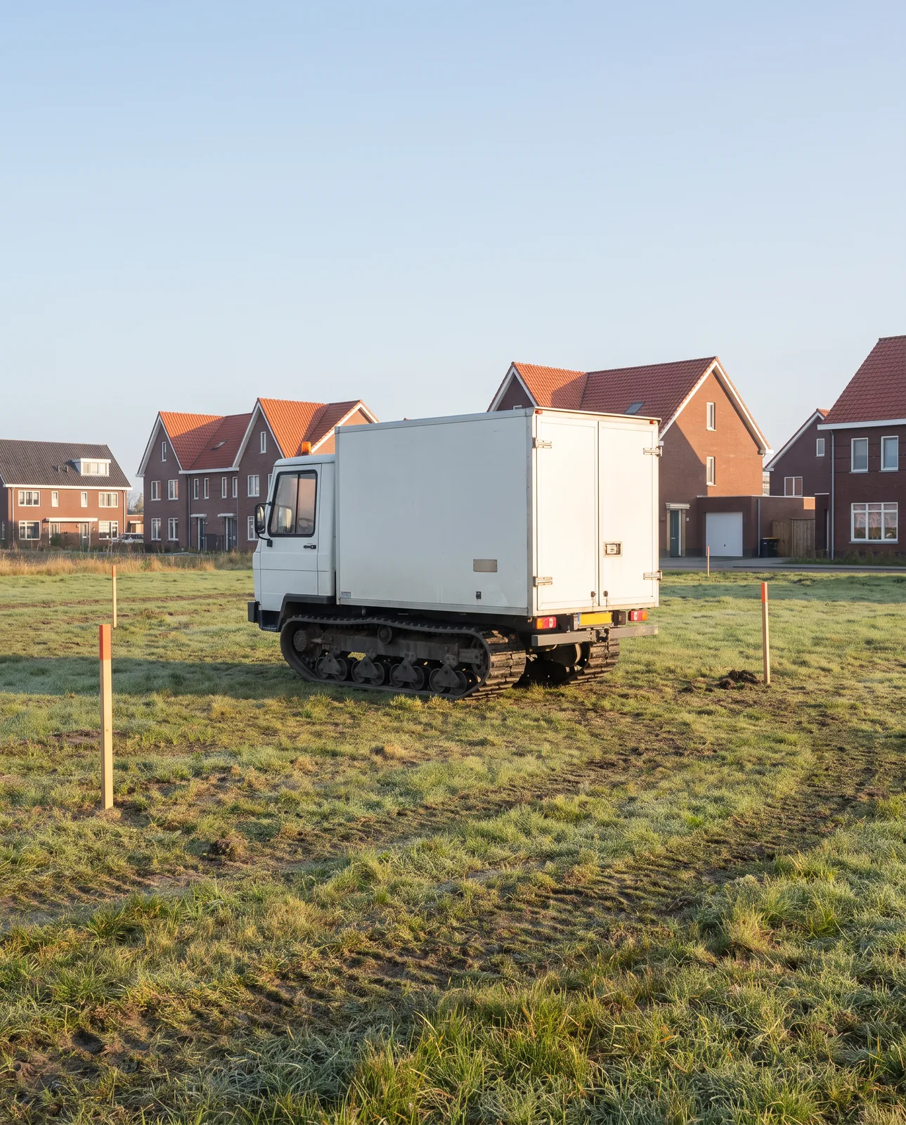 Een sondeerwagen voor grondonderzoek op een lege bouwkavel
